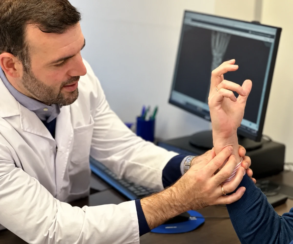Dr Daniel Aedo Martín examining a hand